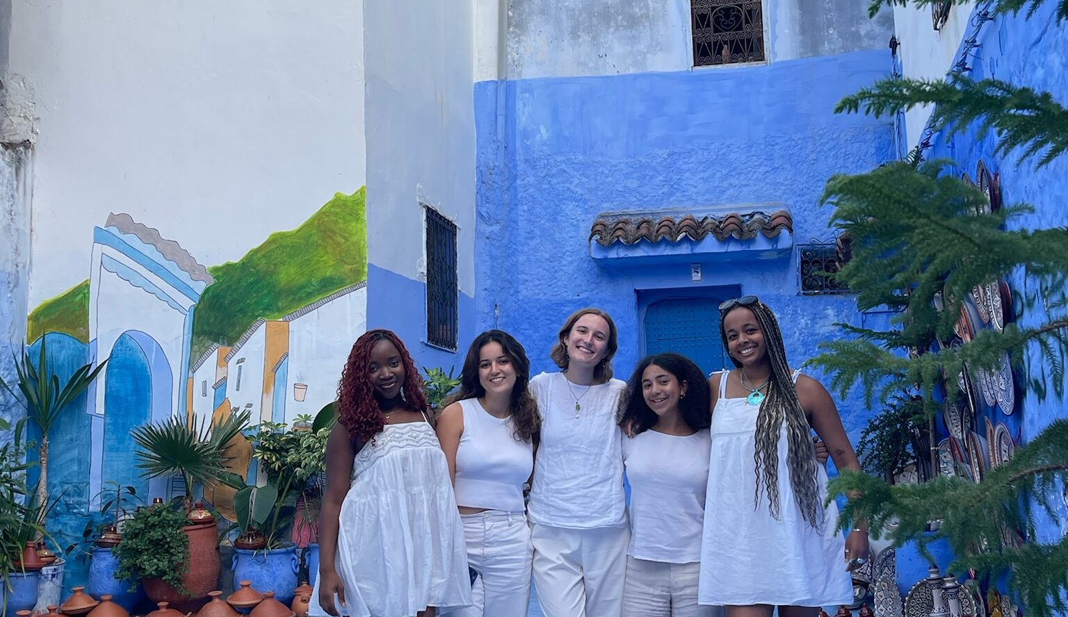 4 girls in white dresses in Morocco blue city