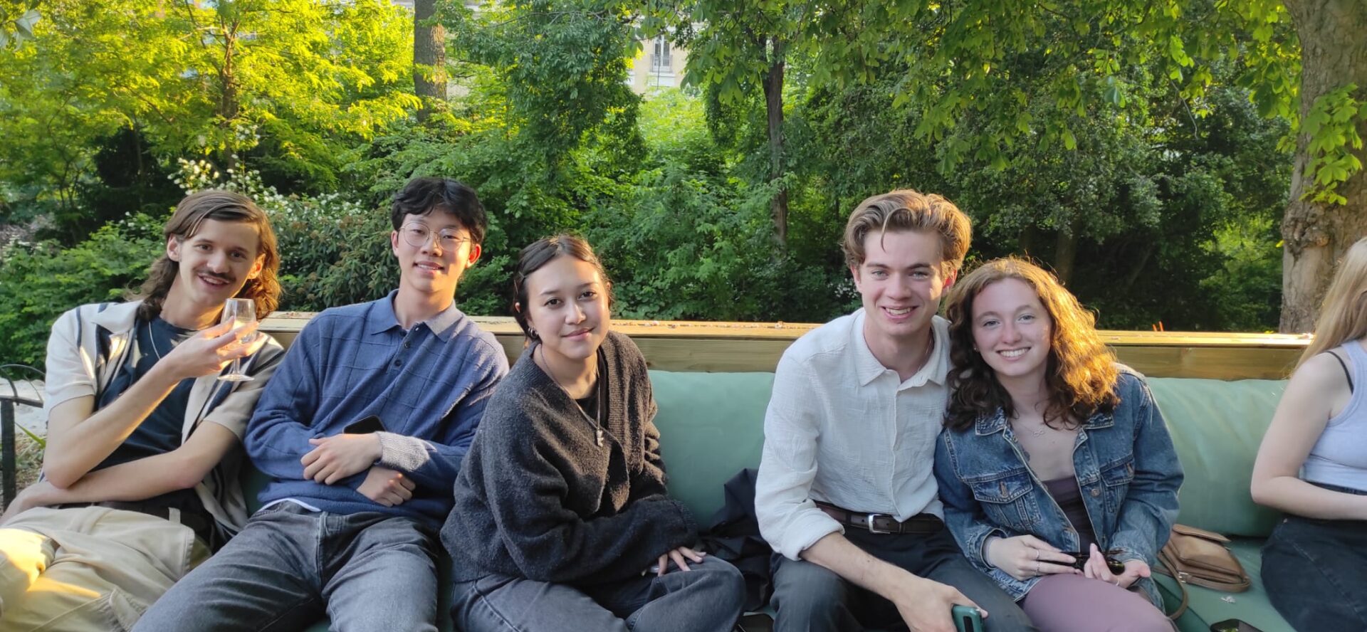 Group of students in garden on a bench in Paris